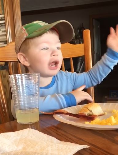 Funny little boy shows how to give directions in the country